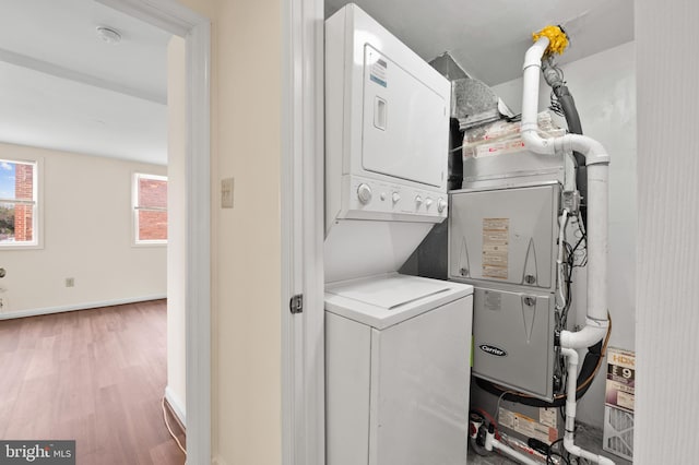 901 W Barre St, Baltimore, MD 21230 - laundry area featuring estacked washer and dryer, wood finished floors, and baseboards