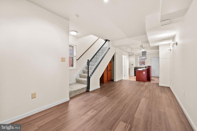 901 W Barre St, Baltimore, MD 21230 - unfurnished living room featuring light wood-style floors, stairway, and baseboards