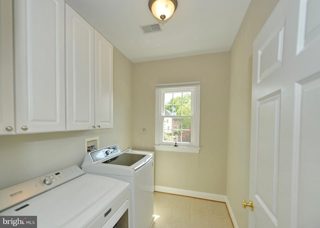 laundry room featuring cabinet space, washer and clothes dryer, baseboards, and light tile patterned floors
