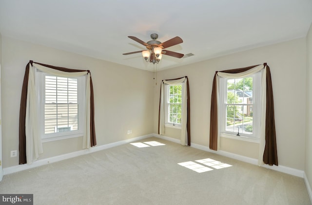 empty room featuring baseboards, carpet flooring, and ceiling fan
