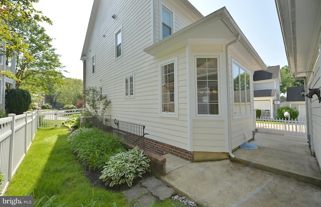 view of home's exterior with cooling unit and a patio