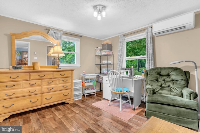 7570 Independence Cir, Charlotte Hall, MD 20622 - sitting room with an AC wall unit, wood finished floors, plenty of natural light, crown molding, and a textured ceiling
