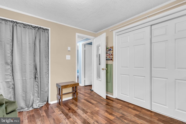 7570 Independence Cir, Charlotte Hall, MD 20622 - unfurnished bedroom featuring wood finished floors, ornamental molding, a textured ceiling, a closet, and baseboards