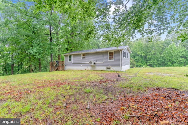 7570 Independence Cir, Charlotte Hall, MD 20622 - back of property featuring stairway, a wooden deck, and a lawn