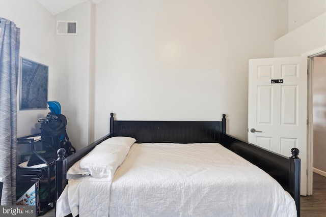 bedroom featuring wood finished floors and vaulted ceiling