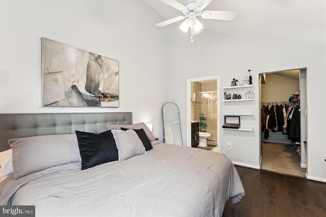 bedroom with a spacious closet, dark wood-style flooring, connected bathroom, high vaulted ceiling, and a closet