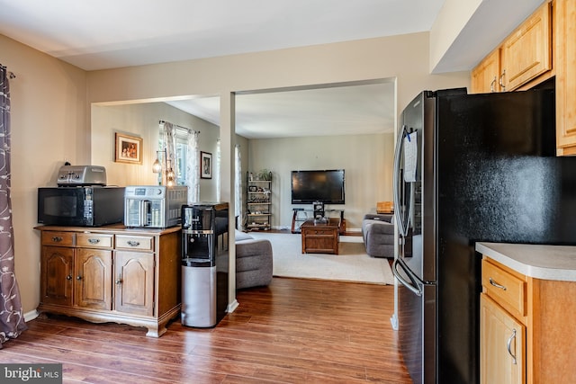 260 Shirley Ln, Pennsburg, PA 18073 - kitchen with freestanding refrigerator, black microwave, wood finished floors, open floor plan, and light countertops