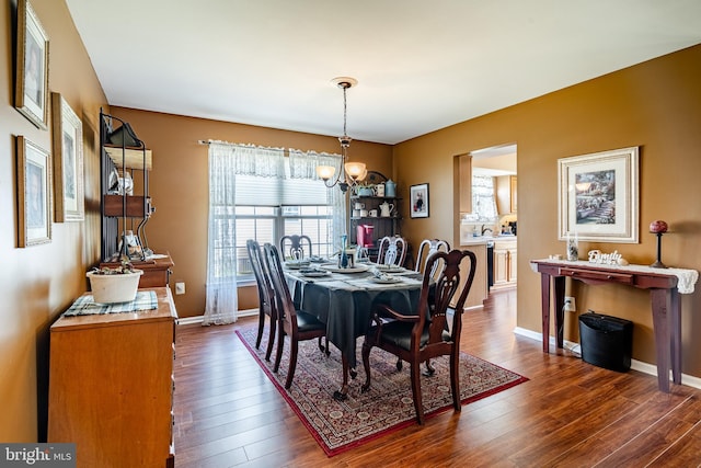 260 Shirley Ln, Pennsburg, PA 18073 - dining area featuring a chandelier, dark wood-style flooring, and baseboards