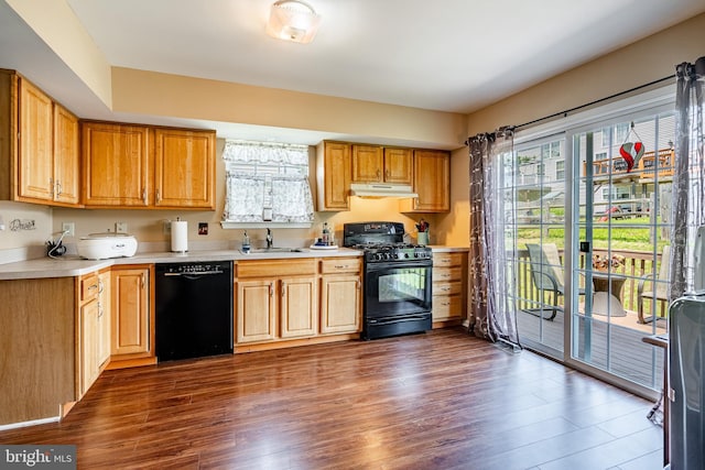 260 Shirley Ln, Pennsburg, PA 18073 - kitchen with black appliances, under cabinet range hood, a sink, light countertops, and dark wood-style floors