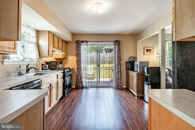 260 Shirley Ln, Pennsburg, PA 18073 - kitchen with black gas stove, a sink, dark wood-style floors, under cabinet range hood, and light countertops