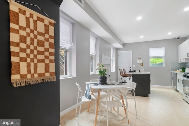 dining room with recessed lighting and baseboards