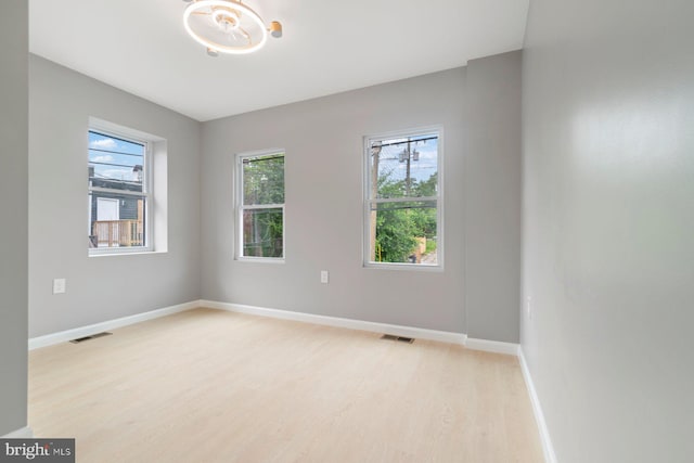 spare room featuring light wood-style flooring and baseboards