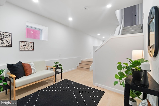 sitting room featuring stairs, wood finished floors, recessed lighting, and baseboards