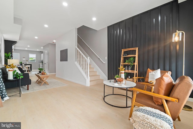 sitting room with stairway, light wood finished floors, recessed lighting, and baseboards