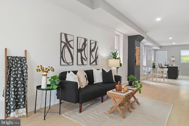 living room featuring wood finished floors, recessed lighting, and baseboards