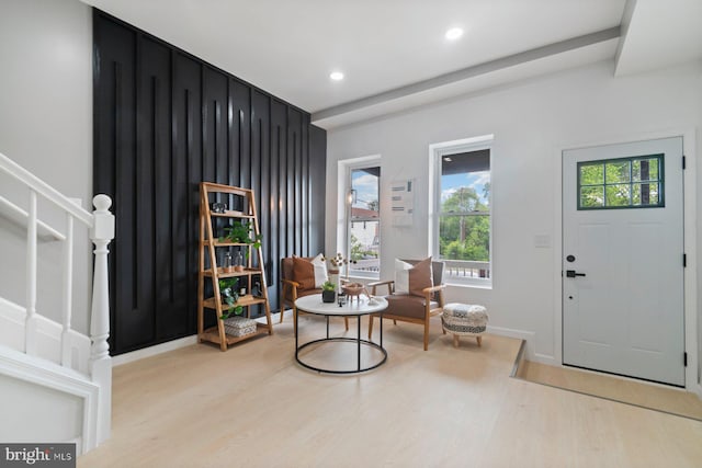 foyer entrance featuring light wood finished floors, stairs, recessed lighting, and baseboards