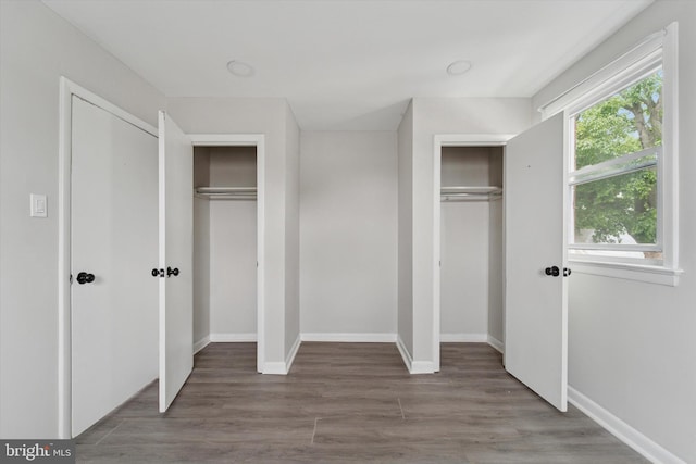 3819-3821 Garrett Rd, Drexel Hill, PA 19026 - unfurnished bedroom featuring multiple closets, wood finished floors, and baseboards