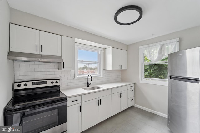 3819-3821 Garrett Rd, Drexel Hill, PA 19026 - kitchen featuring stainless steel appliances, under cabinet range hood, a sink, tasteful backsplash, and light countertops