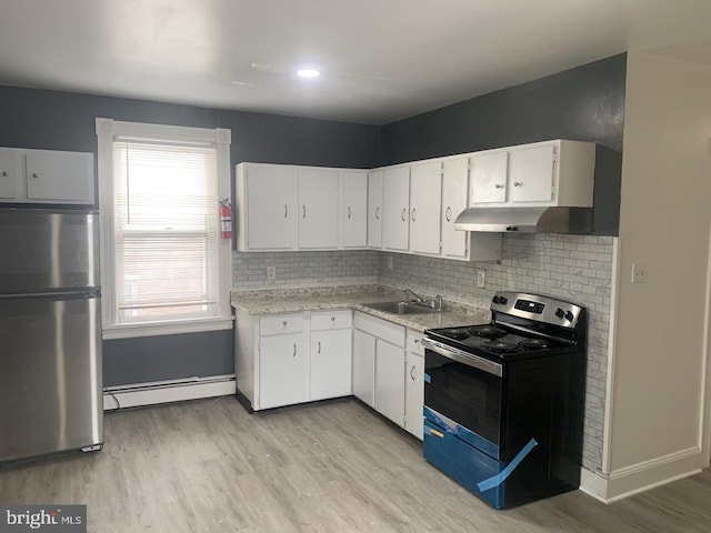 314 W State St, Trenton, NJ 08618 - kitchen with appliances with stainless steel finishes, a baseboard heating unit, a sink, light wood-type flooring, and backsplash