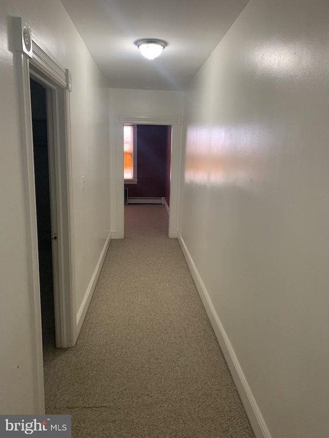 314 W State St, Trenton, NJ 08618 - hallway with light colored carpet, a baseboard radiator, and baseboards