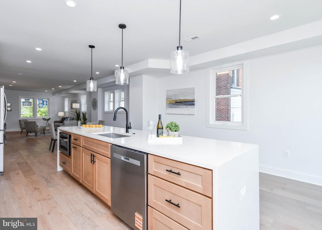 kitchen with appliances with stainless steel finishes, a sink, light brown cabinetry, recessed lighting, and light wood-style flooring