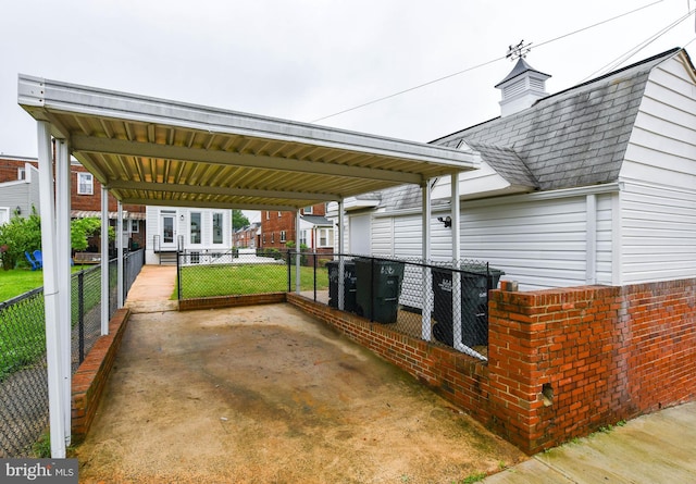 view of patio with a carport and fence