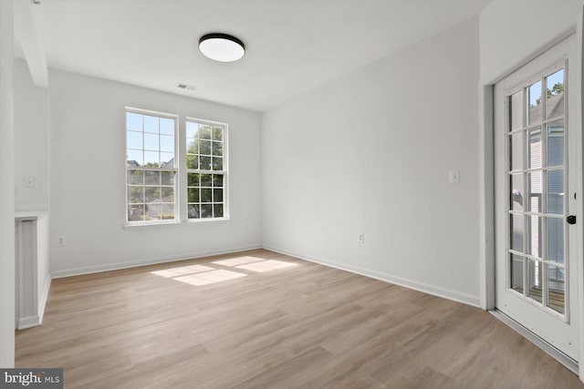 unfurnished room featuring light wood finished floors and baseboards