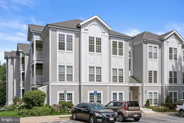 view of building exterior with uncovered parking