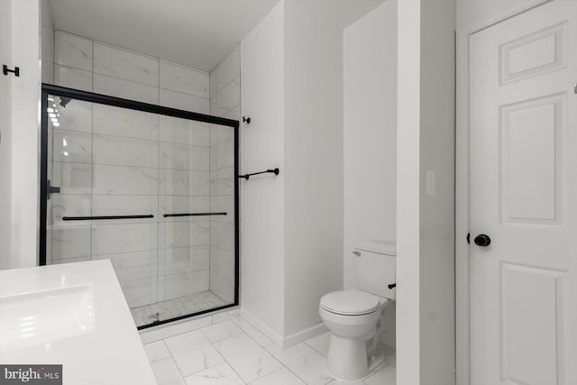 bathroom featuring marble finish flooring, baseboards, a stall shower, and toilet