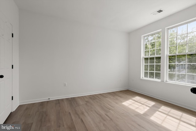 spare room with wood finished floors and baseboards