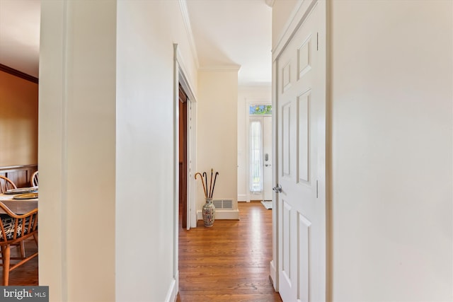 hall with crown molding, wood finished floors, and baseboards