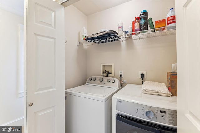 clothes washing area with washing machine and clothes dryer