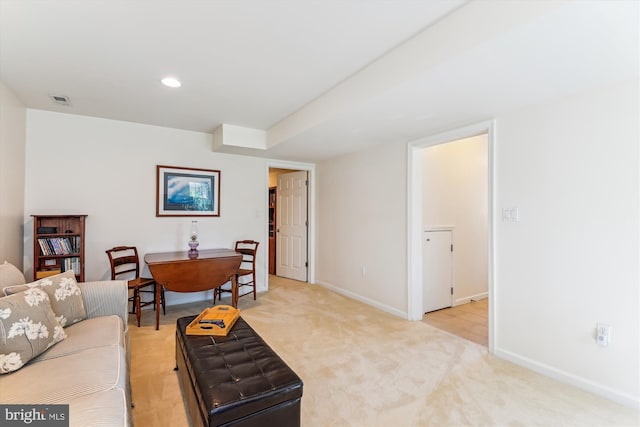 living room with light carpet and baseboards