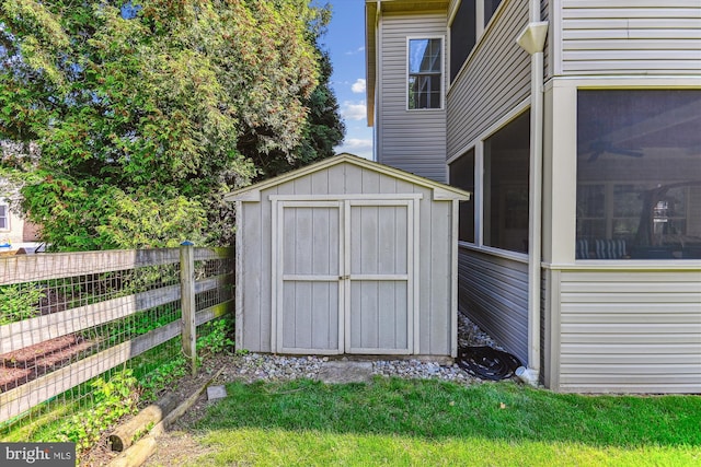 view of shed with fence