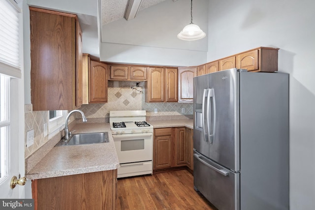 455 Commodore Dr, Forked River, NJ 08731 - kitchen featuring stainless steel refrigerator with ice dispenser, white gas range, decorative backsplash, dark wood-style floors, and light countertops