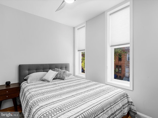 418 E Lanvale St, Baltimore, MD 21202 - bedroom featuring multiple windows, wood finished floors, and ceiling fan