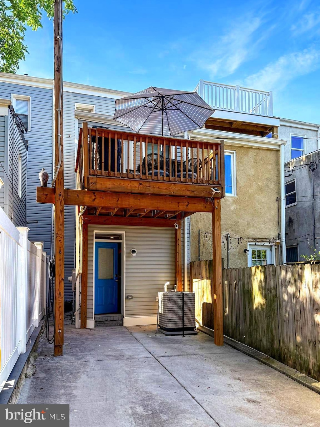 418 E Lanvale St, Baltimore, MD 21202 - back of property with central AC, a fenced backyard, a patio area, and a wooden deck
