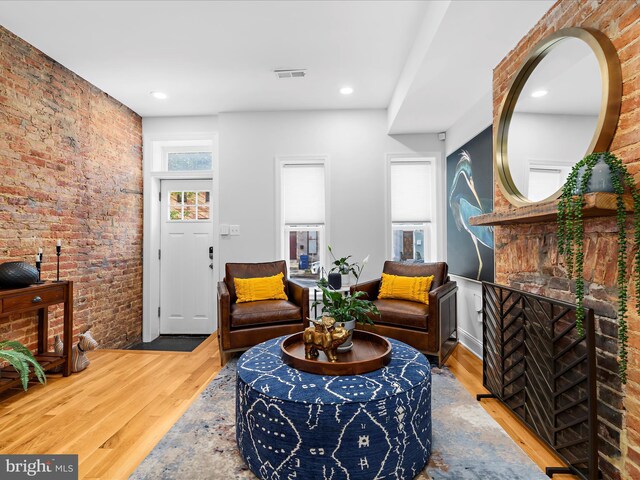 418 E Lanvale St, Baltimore, MD 21202 - sitting room featuring brick wall, wood finished floors, and recessed lighting