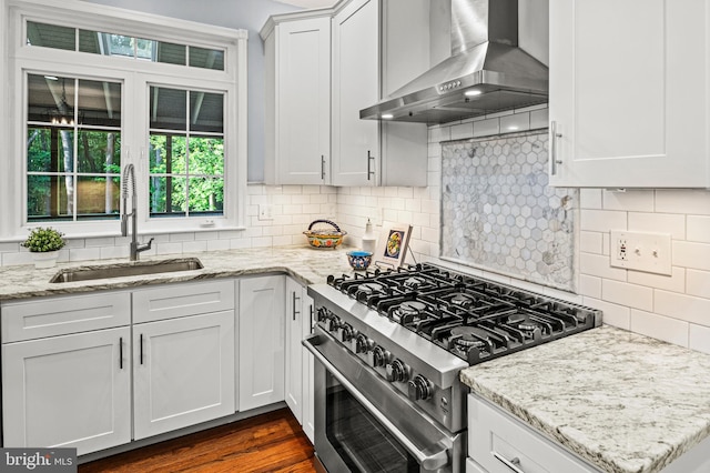 9609 Low Meadow Dr, Gaithersburg, MD 20882 - kitchen featuring high end stainless steel range oven, wall chimney range hood, a sink, and white cabinets