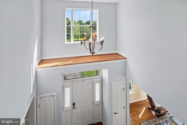 9609 Low Meadow Dr, Gaithersburg, MD 20882 - foyer with a chandelier, plenty of natural light, wood finished floors, baseboards, and a towering ceiling