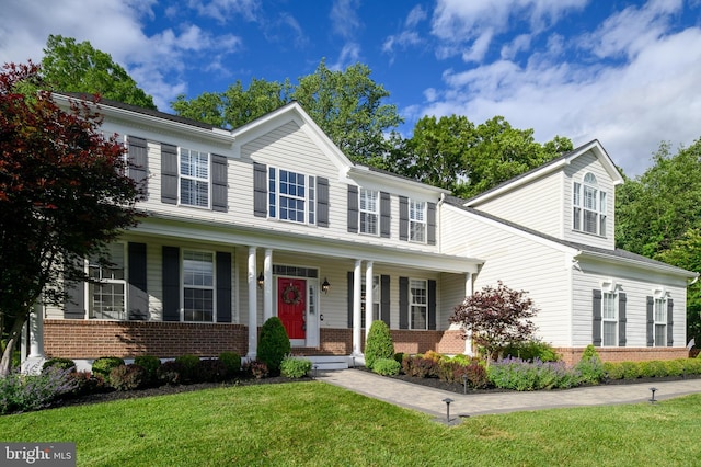 9609 Low Meadow Dr, Gaithersburg, MD 20882 - view of front of house featuring brick siding, a porch, and a front yard