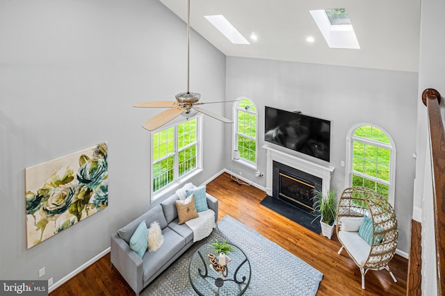9609 Low Meadow Dr, Gaithersburg, MD 20882 - living room with high vaulted ceiling, a skylight, healthy amount of natural light, a fireplace with flush hearth, and wood finished floors