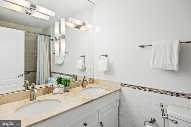 9609 Low Meadow Dr, Gaithersburg, MD 20882 - bathroom featuring toilet, double vanity, a tile shower, tile walls, and a wainscoted wall