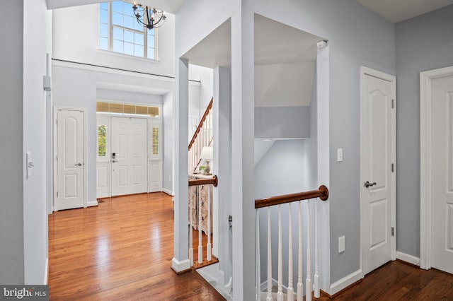 9609 Low Meadow Dr, Gaithersburg, MD 20882 - foyer featuring wood finished floors, a chandelier, baseboards, and a high ceiling
