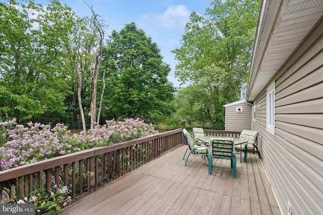 318 Spring Lake Blvd, Browns Mills, NJ 08015 - wooden terrace featuring outdoor dining area and view of wooded area