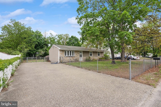 318 Spring Lake Blvd, Browns Mills, NJ 08015 - view of front of property with stone siding, fence, and asphalt driveway