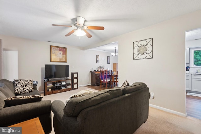 318 Spring Lake Blvd, Browns Mills, NJ 08015 - living room featuring a ceiling fan, light colored carpet, baseboards, and a chandelier