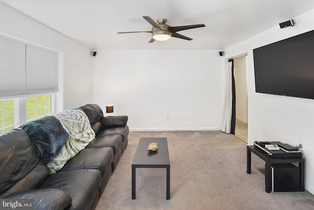 living room featuring ceiling fan, carpet floors, and baseboards
