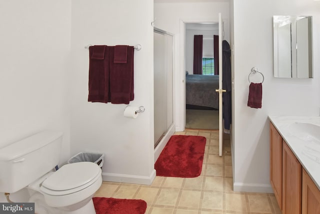 full bathroom featuring baseboards, vanity, a stall shower, and toilet