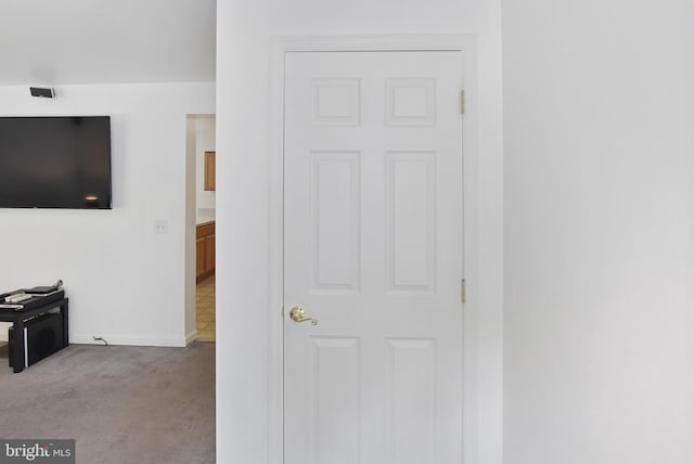 corridor with carpet flooring and baseboards